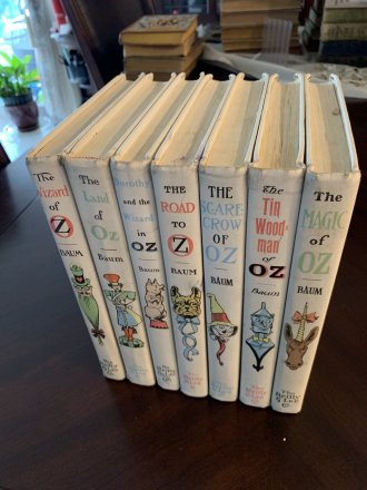 Set of 7 Frank Baum Oz books. White cover edition. Printed circa 1965 - $150.0000